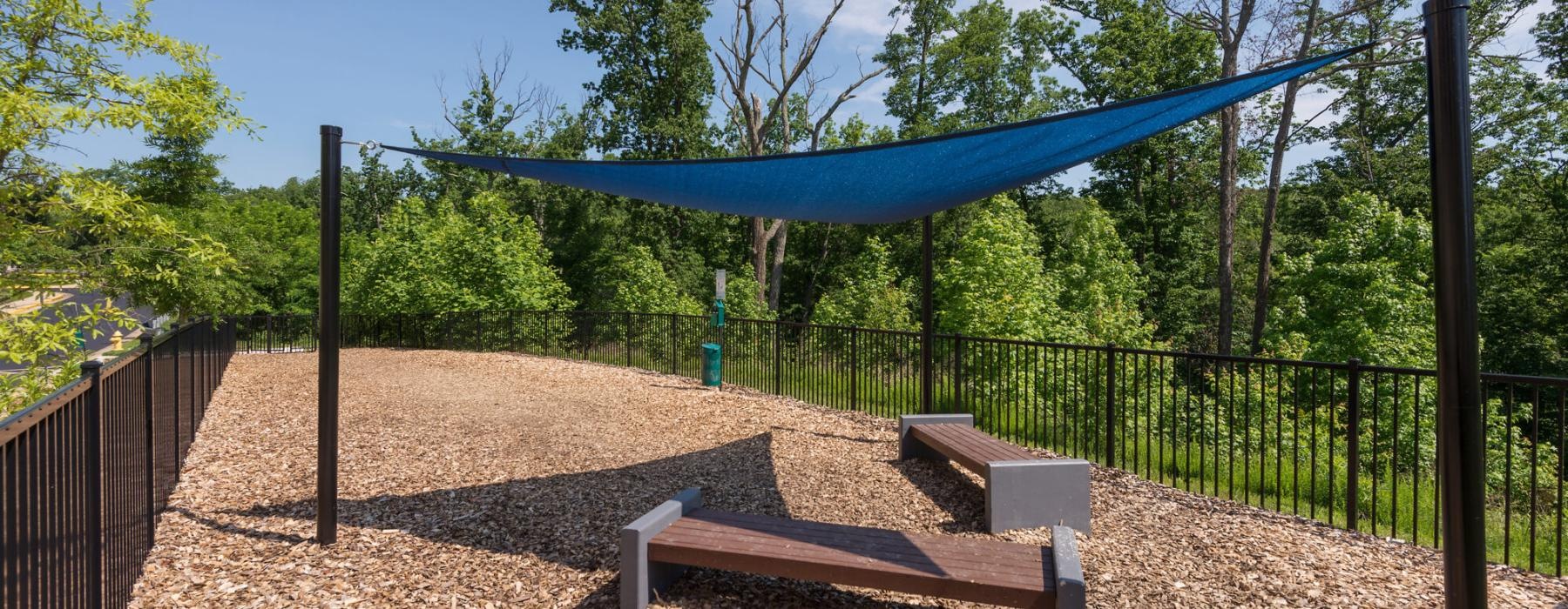 a dog park with cover and benches