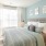 Model bedroom at Victor Stonebridge Apartments in Woodbridge, VA, featuring carpeted flooring and windows with blinds.