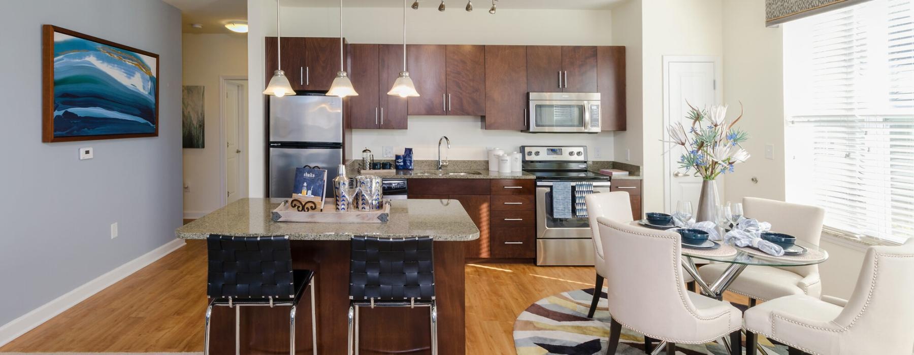 a kitchen with a dining table and chairs