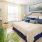 Model bedroom at Victor Stonebridge apartments for rent in Woodbridge, featuring carpeted flooring and windows with blinds.