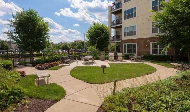 Settle into comfort at Bell Stonebridge The outdoor lounge at Victor Stonebridge Apartments in Woodbridge, VA, featuring grill stations and outdoor furniture.